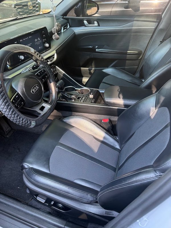 Clean front seats, console and dashboard of the detailed Kia.